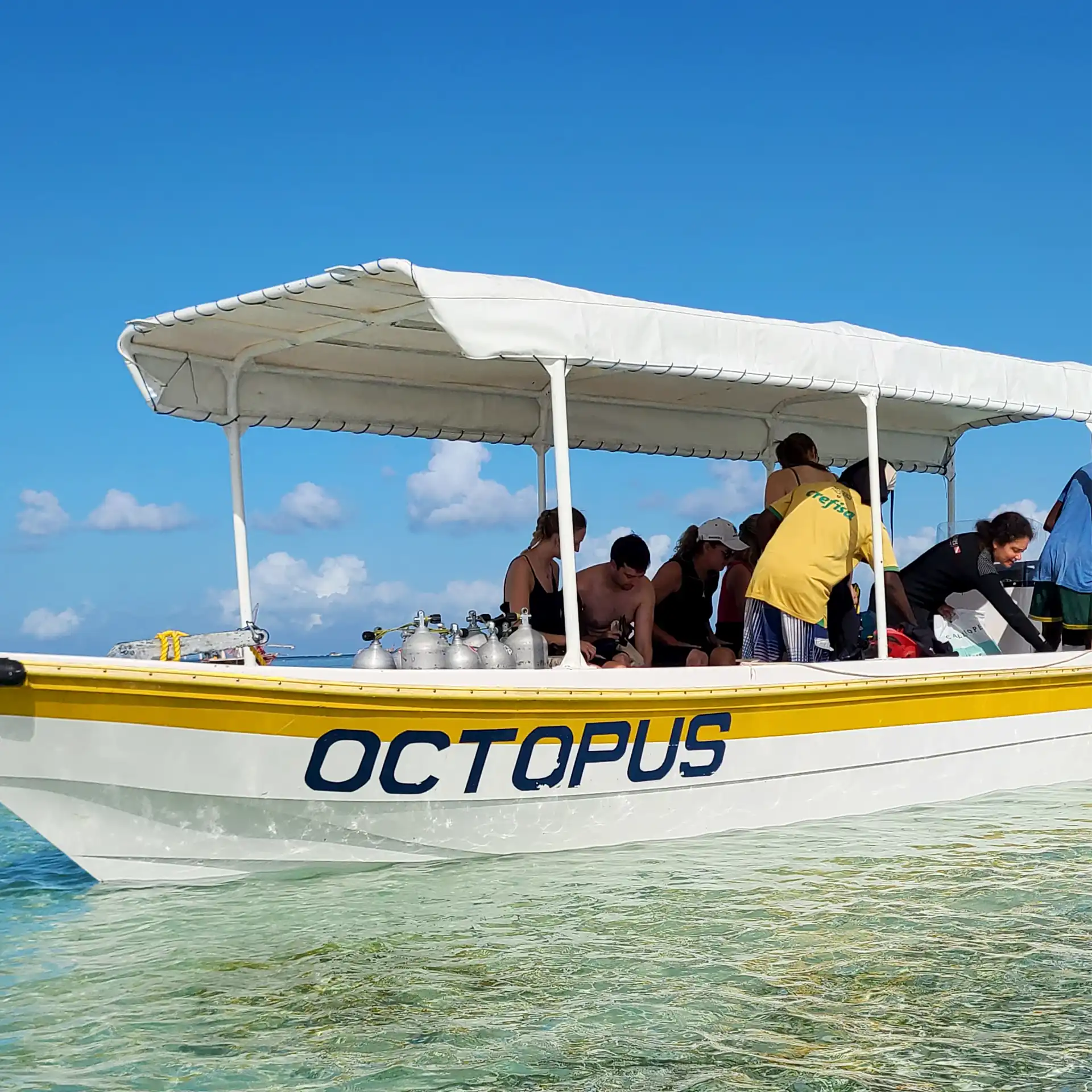 Divers boarding the shaded comfortable Octopus speedboat on Nungwi Beach in Zanzibar for a daily dive excursion