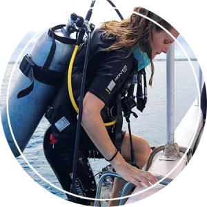 Scuba diver with premium gear boarding a Fun Divers Zanzibar speedboat at Mnemba Island