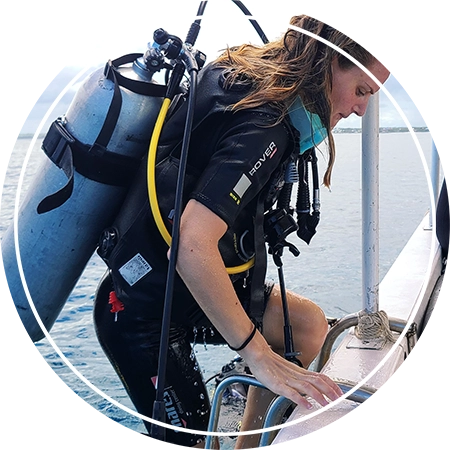 Scuba diver with premium gear boarding a Fun Divers Zanzibar speedboat at Mnemba Island