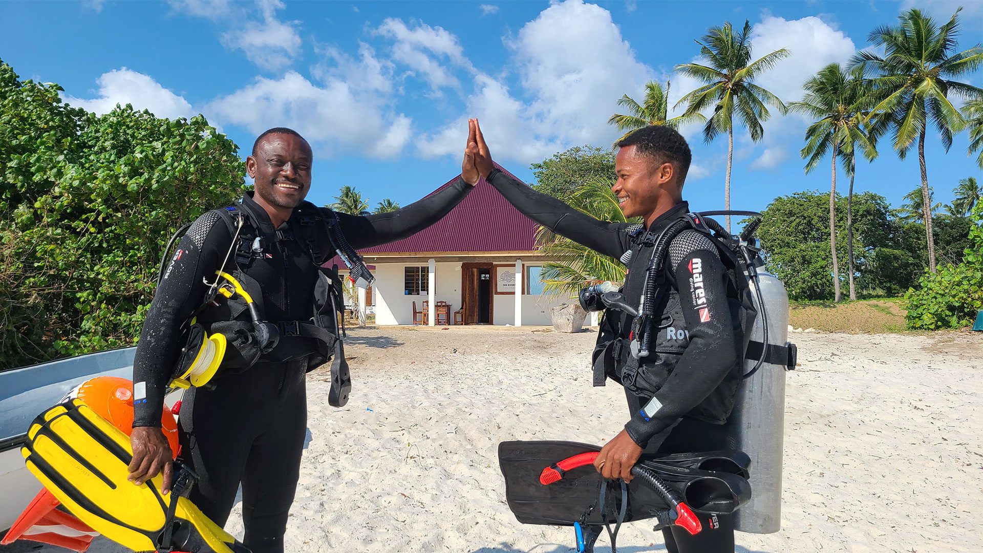 Dive team in dive gear in front of the Pemba dive center